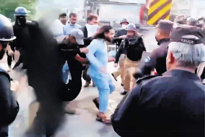 Pic of Activist being carried by Police in Pok