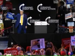 Former US President and 2024 Republican presidential candidate Donald Trump raises his fist as he walks off stage after participating in a town hall event at Dream City Church in Phoenix, Arizona, on June 6, 2024.